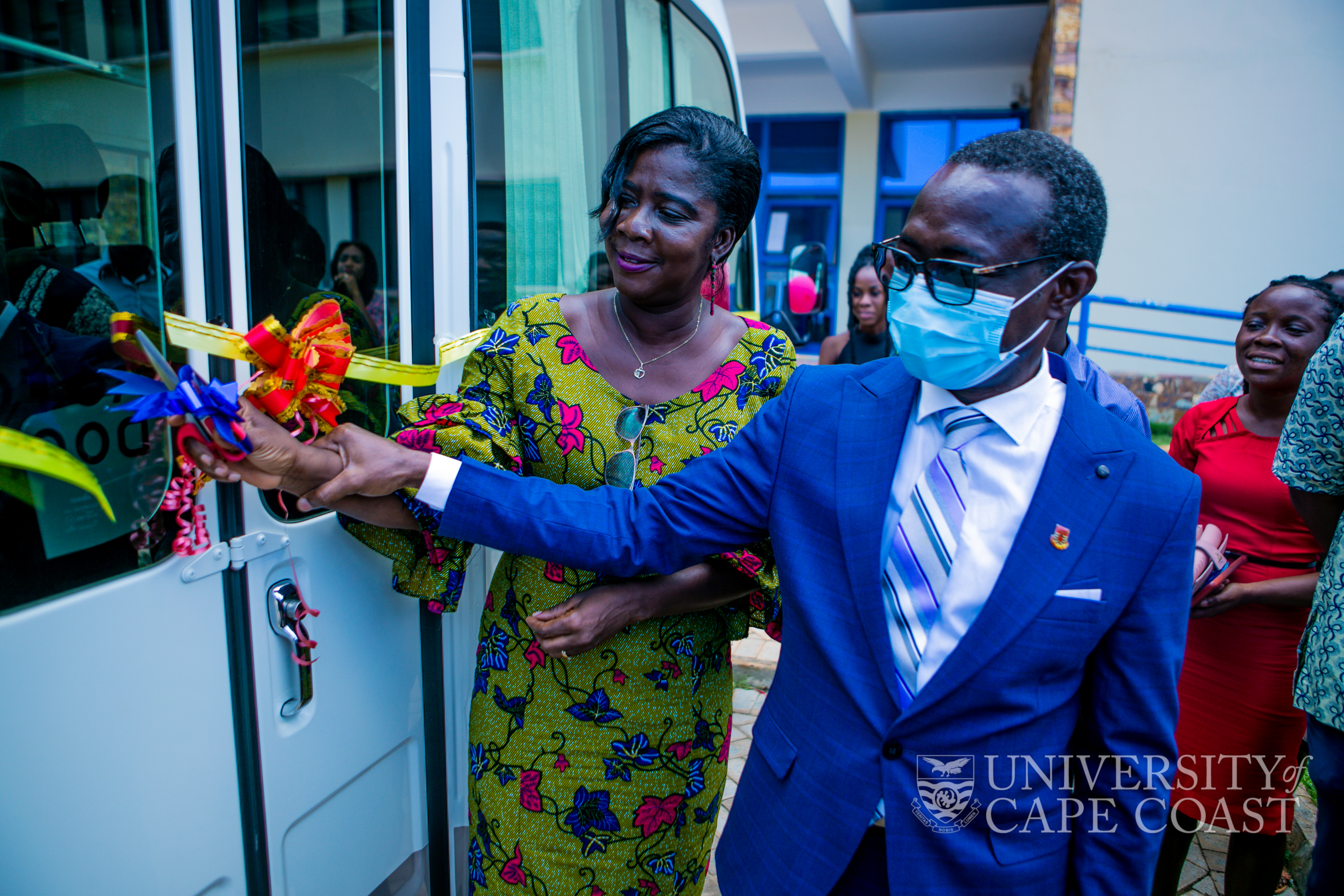 Pro Vice-Chancellor of UCC, Prof. Rosemond Boohene, being assisted by the Vice-Chancellor to cut the tape to commission the bus Pro Vice-Chancellor of UCC, Prof. Rosemond Boohene, being assisted by the Vice-Chancellor to cut the tape to commission the bus