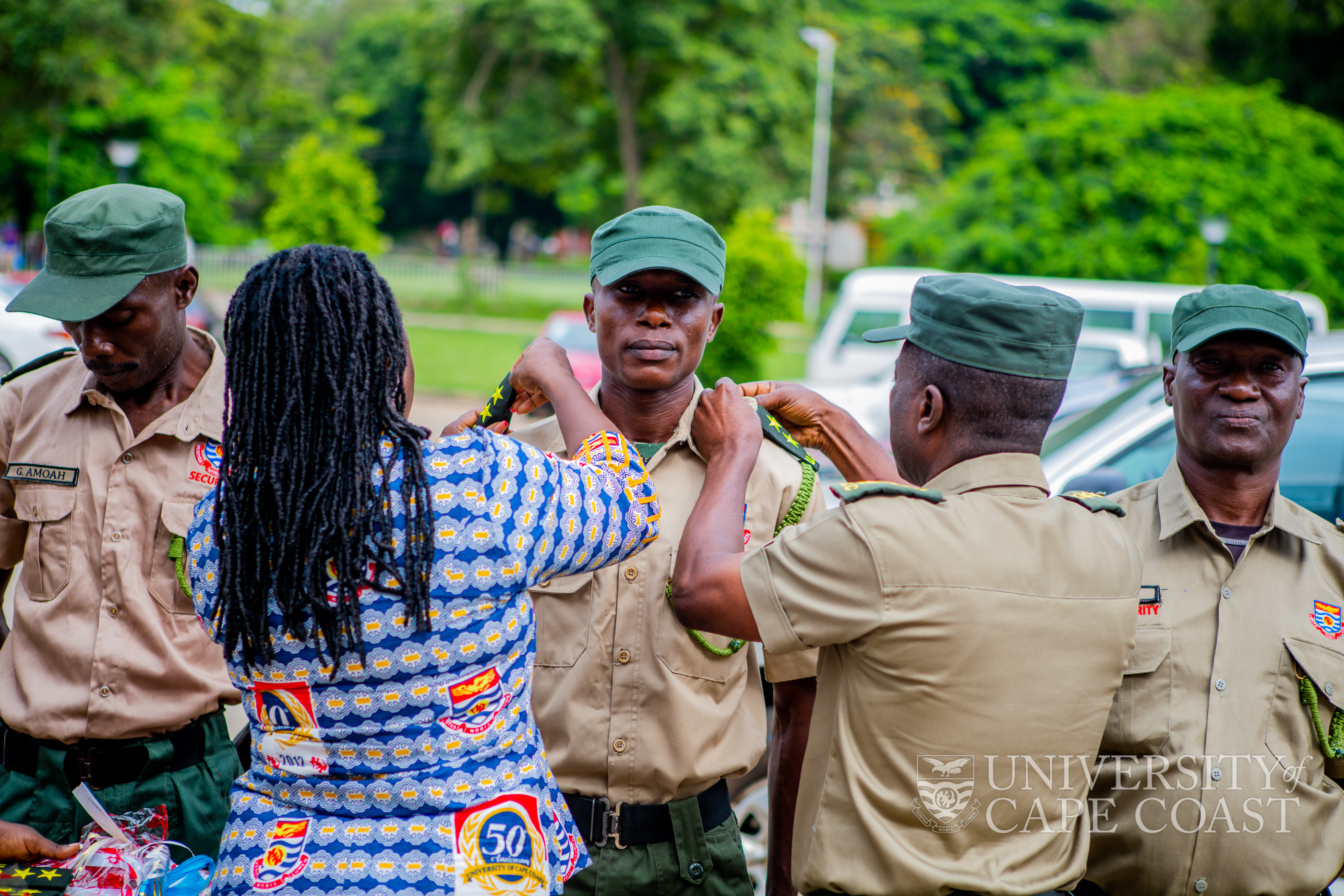 Mrs Graham(left) decorating a promoted security personnel at maiden Rank Wearing Ceremony Mrs Graham(left) decorating a promoted security personnel at maiden Rank Wearing Ceremony