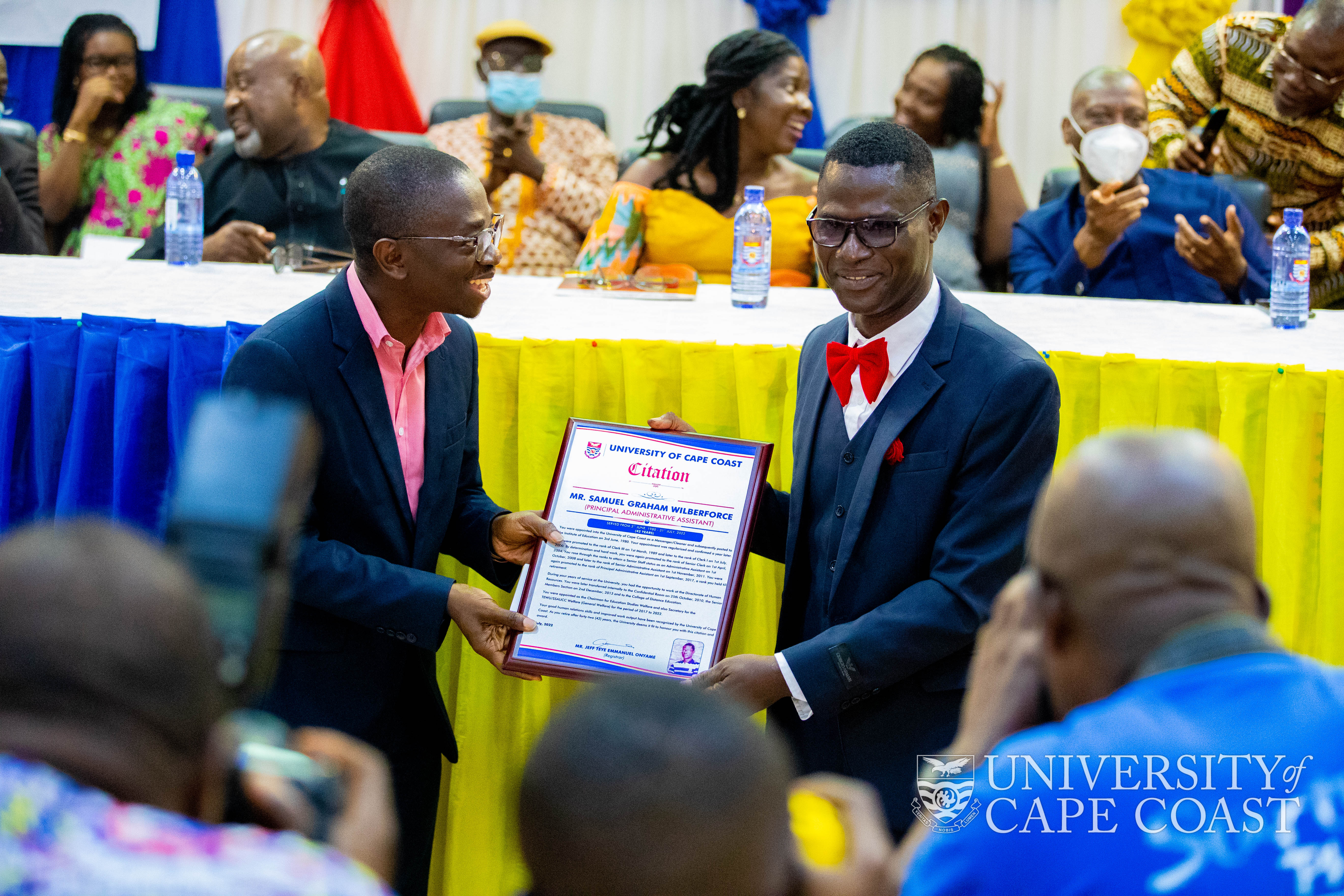 Samuel Wilberforce Graham (right) who served 42 years receiving a citation from President of UTAG-UCC, Dr. Bert Boadi Kusi