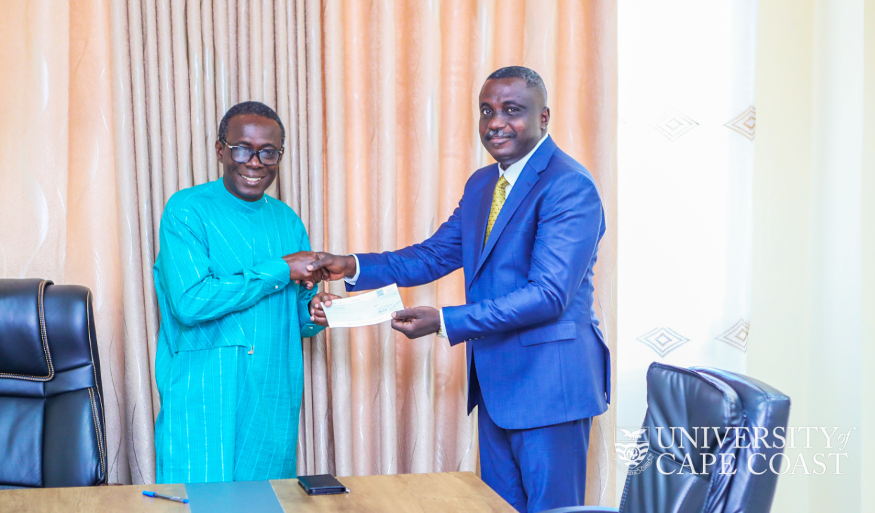 Mr. Joshua Dadzie presenting the cheque to the Vice-Chancellor, Prof. Johsson Nyarko Boampong. Mr. Joshua Dadzie presenting the cheque to the Vice-Chancellor, Prof. Johsson Nyarko Boampong.