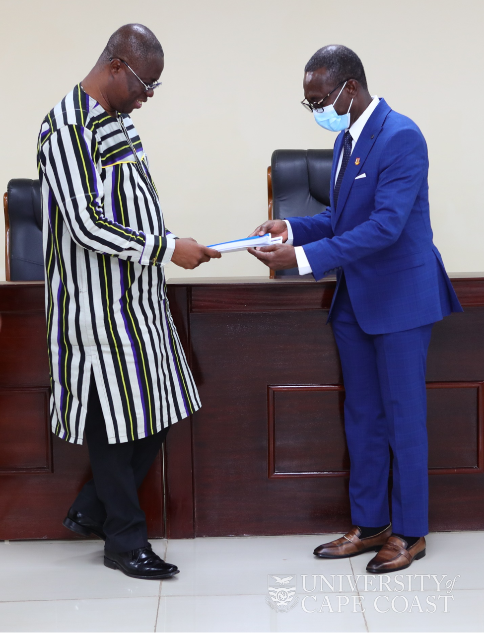 Chairman of the Committee, Prof. Ghartey Ampiah (left) presenting the Committee’s report to the VC, Prof. Nyarko Boampong