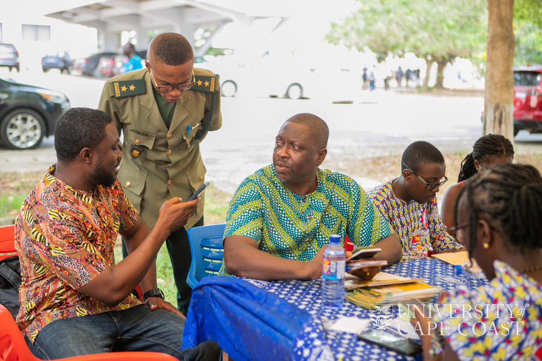 An Immigration Officer assisting some participants