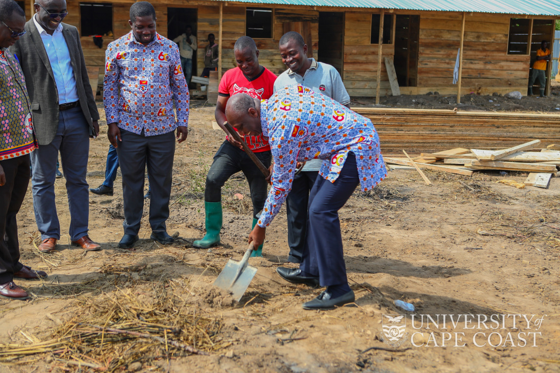 The Registrar cutting the sod