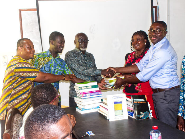 REACT Humanitarian Networkpresenting books to the School of Economics
