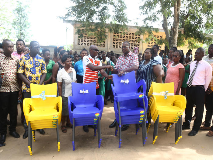 Prof. Sampson Nyarko-Sampson presenting the chairs to the headteacher of the School Prof. Sampson Nyarko-Sampson presenting the chairs to the headteacher of the School