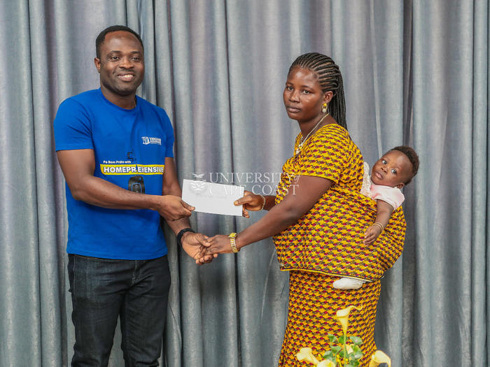 Vanguard Assurance Company Limited donating Gh¢ 10,000 to the widow of a deceased staff member of UCC, Mr. Benjamin Atiaba.
