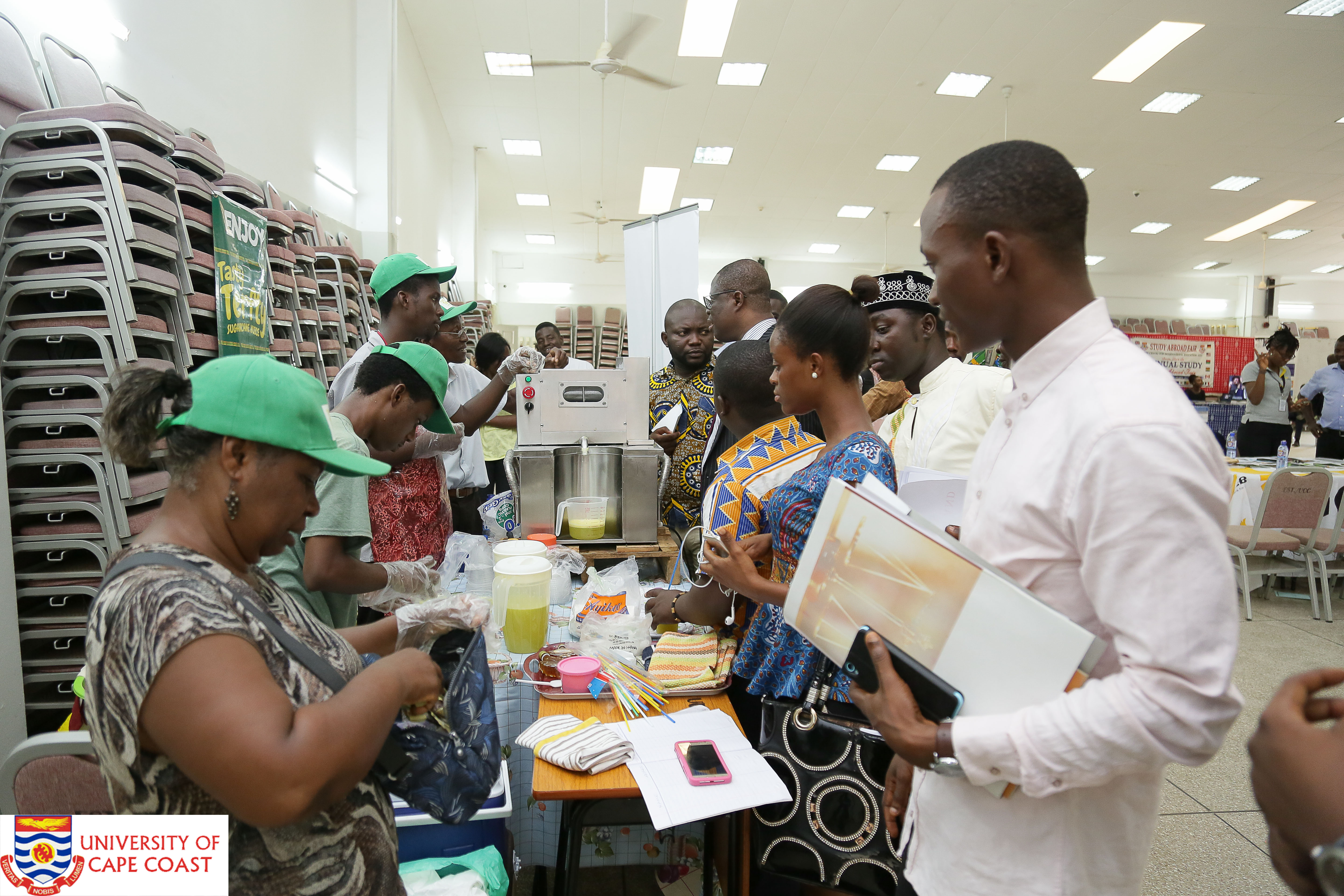 People in green hat exhibiting proccessed juice