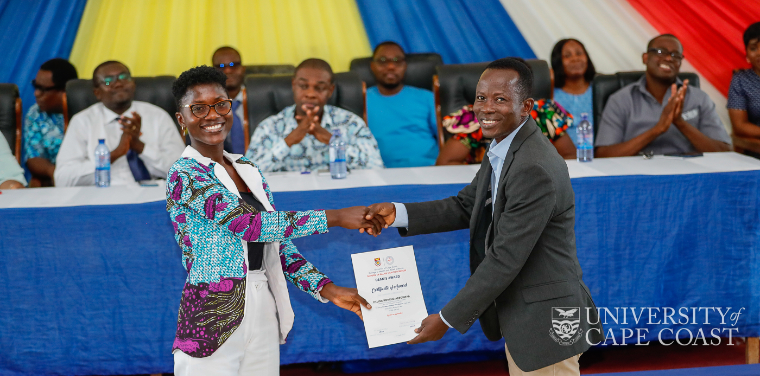 A female student receiving her certificate of honour for her sterling academic performance