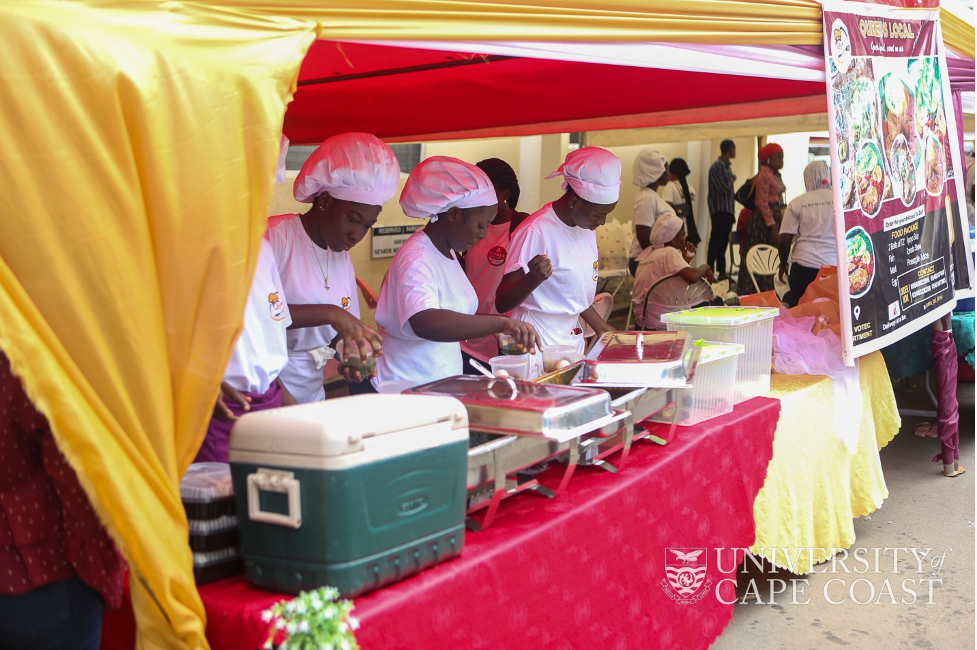 Some students behind their food stand ready to serve their clients